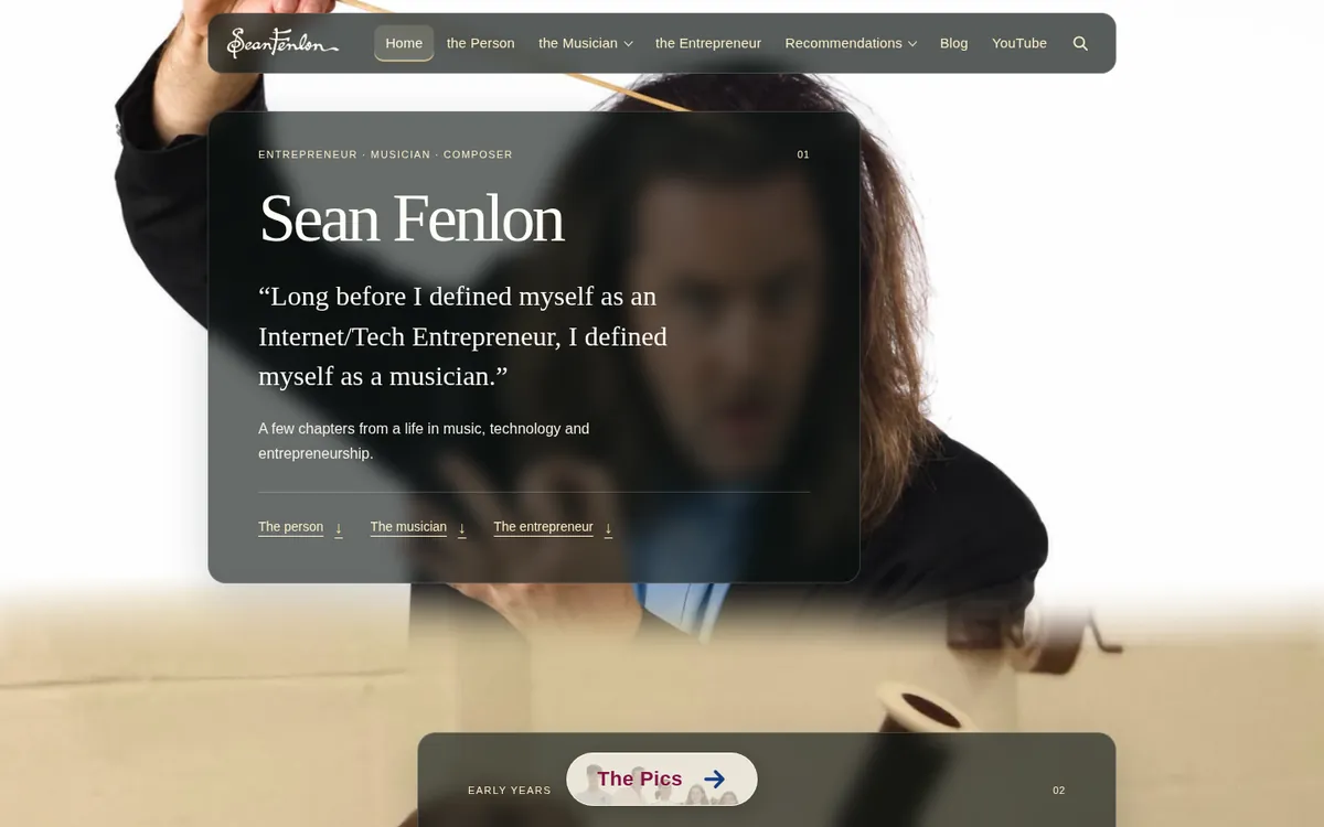 The new SeanFenlon.com home page on a desktop browser: a translucent text panel reading “Sean Fenlon” over a large photo of Sean conducting, with the menu across the top and The Pics button at the bottom.